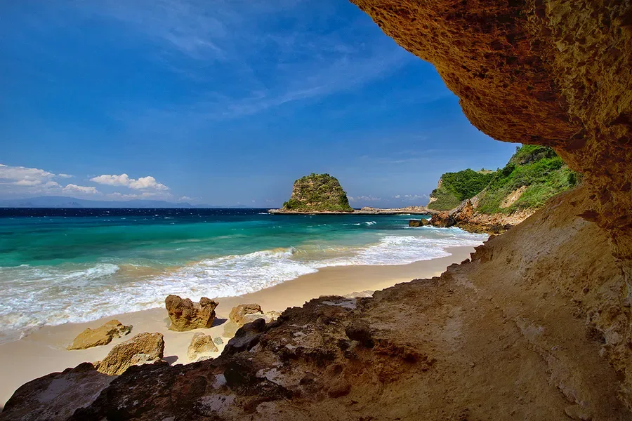 Sandy cove viewed from a coastal rock shelter